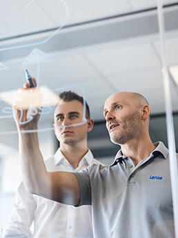 Two Lenze software engineers working together and visually planning a project for easy engineering tools.