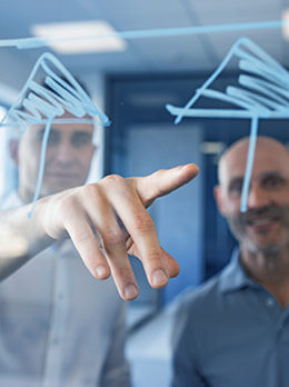 Two people sketching plant concept on glass wall for engineering and industrial automation